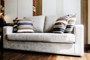 Couch with cushions and throw pillows that need to be fluffed